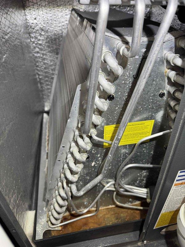 Performed scheduled heating maintenance service on furnace system. Inspected evaporator coil assembly and noted some condensation present. Conducted temperature differential testing using Testo 310 analyzer, confirming system is operating within normal parameters with readings of 67° and 95.2°.