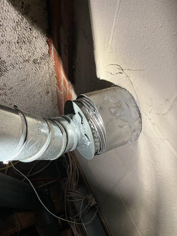 Conducted comprehensive assessment of aging water heater system including tank condition, connection points, and ventilation ductwork. Identified deterioration at duct-wall junction with visible cracking and potential leakage concerns. Documented existing copper supply lines, pressure relief valve, and galvanized elbow configuration for replacement specifications.