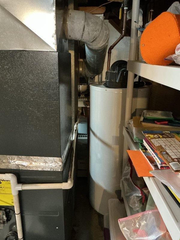 Conducted scheduled heating maintenance on furnace system. Performed combustion analysis with Klein Tools ET180 Differential Manometer, confirming gas pressure at 3.13" WC, within manufacturer specifications. Inspected water heater and surrounding mechanical area for proper clearances and ventilation in the confined utility space.