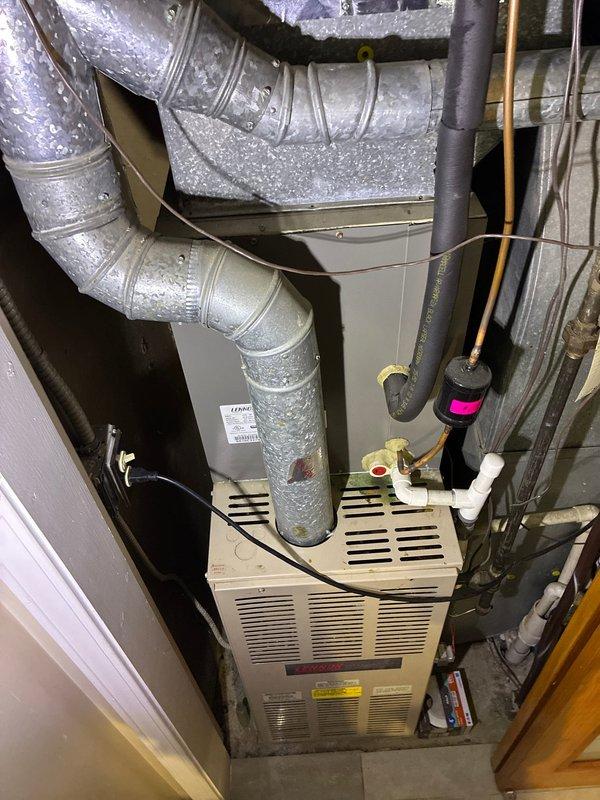 Conducted assessment of 30-year-old first floor furnace system for replacement options through insurance claim. Inspected existing installation including aged furnace unit, connected galvanized sheet metal ductwork, and associated refrigerant lines. Documented current system configuration including insulated piping, drainage components, and electrical connections to determine appropriate replacement specifications.