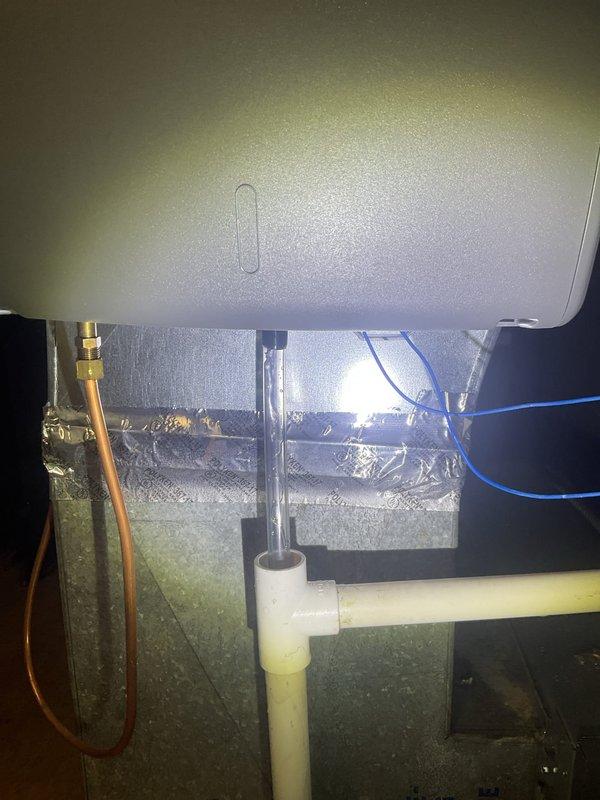 Responded to service call for furnace with water pooling around base. Inspected HVAC system including air handler, condensate drainage components, and associated PVC piping. Identified and corrected condensate drain issue causing water accumulation on utility room floor.