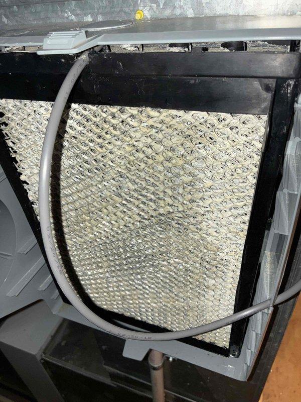 Responded to service call regarding water leakage from humidifier after customer replaced water panel. Inspection revealed significant damage to the humidifier control panel with multiple burn/melt holes compromising the unit's integrity. Replaced damaged control panel and verified proper operation with no further leakage.