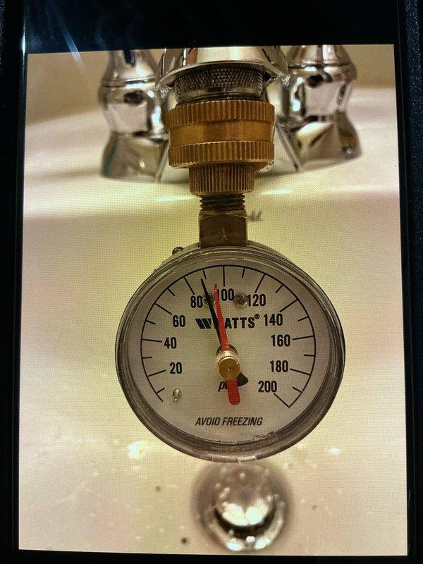 Responded to service call for water heater leaking into drain pan. Diagnostic testing revealed system pressure at approximately 100 PSI, significantly exceeding recommended levels. Adjusted pressure regulator and verified proper operation of the expansion tank to resolve leak issue.