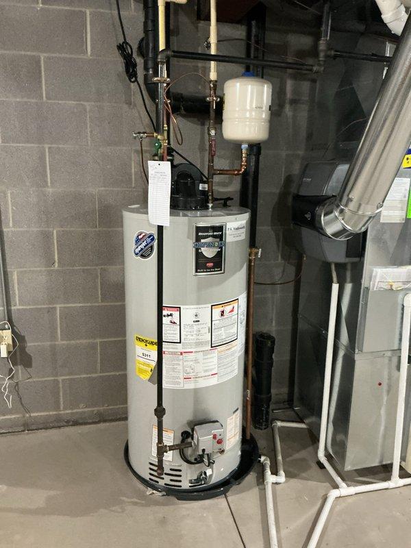 Responded to service call for water heater leaking into drain pan. Diagnostic testing revealed system pressure at approximately 100 PSI, significantly exceeding recommended levels. Adjusted pressure regulator and verified proper operation of the expansion tank to resolve leak issue.