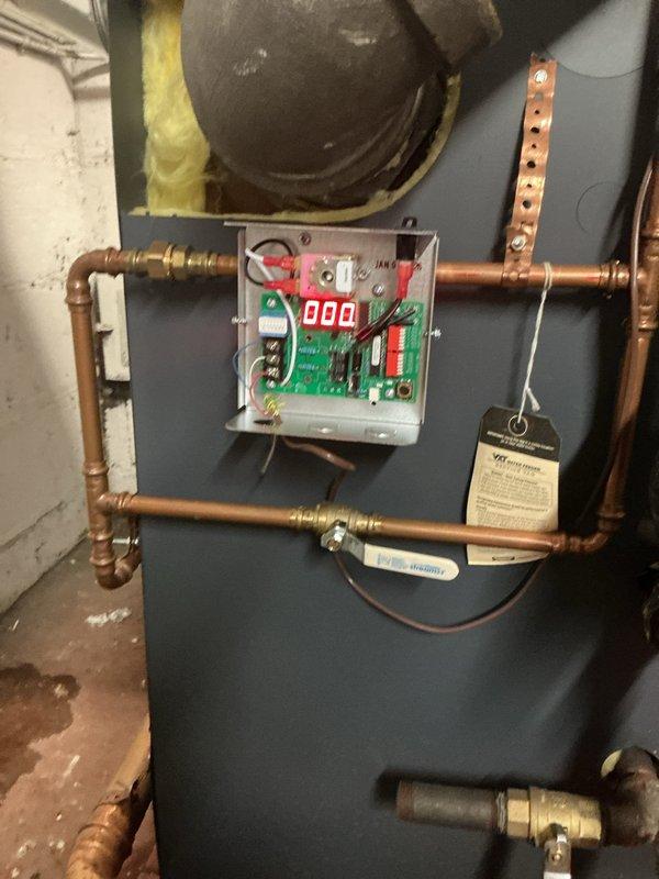 Performed second service call to address system issues. Inspected copper piping configuration and replaced sight glass assembly. Verified proper operation of electronic control module displaying "000" on digital readout after installation and system restart.