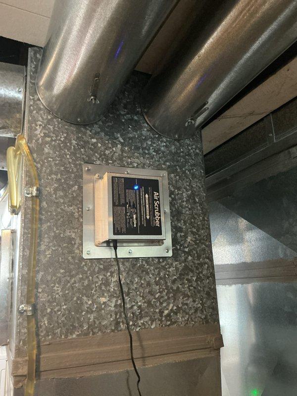 Performed scheduled maintenance on residential HVAC heating system with AirScrubber air purification device. Inspected furnace unit with dual PVC ventilation pipes for proper operation and airflow. System functioning normally with no issues identified; equipment appears to be in good working condition with all safety features operational.