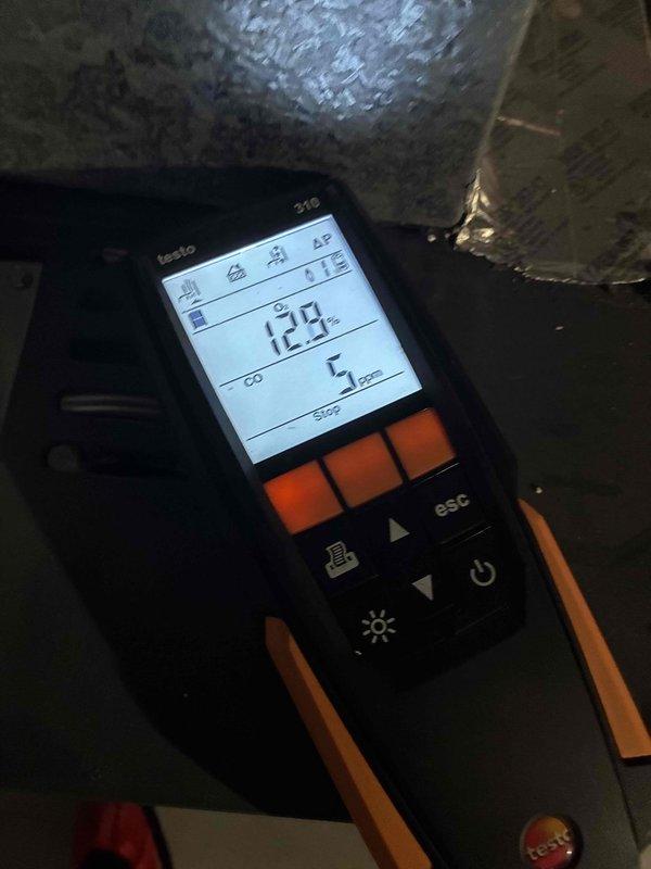 Performed routine heating system maintenance including filter replacement and combustion analysis. Removed and replaced air filter (16x25) and conducted combustion efficiency testing with Testo analyzer, which showed 12.9% CO2 and 5ppm CO levels, indicating proper system operation.