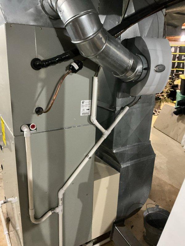 Performed scheduled heating maintenance service on dual system installation. Inspected primary furnace unit with connected ductwork and PVC venting; all components found in proper working condition with no visible issues. Examined Aprilaire Model 600M humidifier; verified proper mounting and functionality with no signs of damage or corrosion.