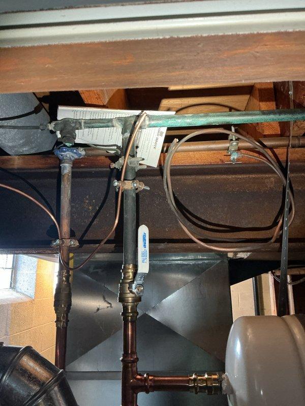 Performed scheduled hot water tank maintenance. Inspected copper supply lines, pressure relief valve, and brass fittings for proper operation and signs of leakage. Verified secure attachment of flexible connectors and examined tank for proper venting configuration.