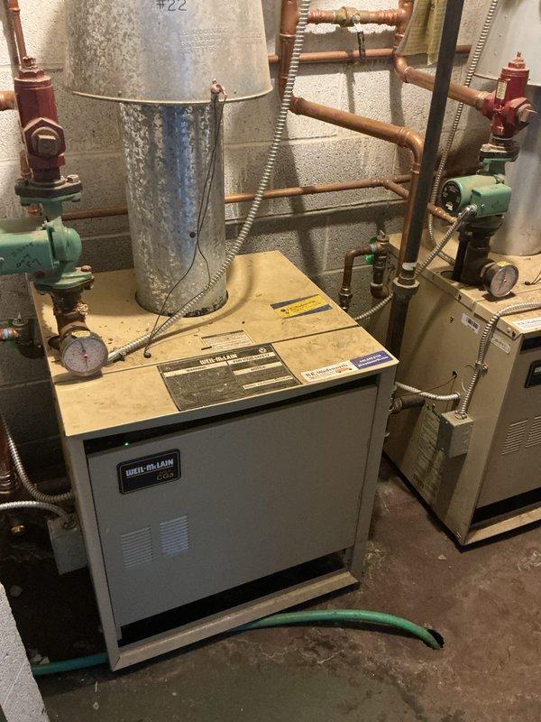 Performed scheduled heating maintenance on dual-system installation consisting of a Weil-McLain boiler with associated copper piping and expansion tank, plus secondary heating loop with red pump assembly. Inspected all components including valves, pressure gauges, and electrical connections; confirmed proper operation of both systems with no leaks or abnormal wear detected.