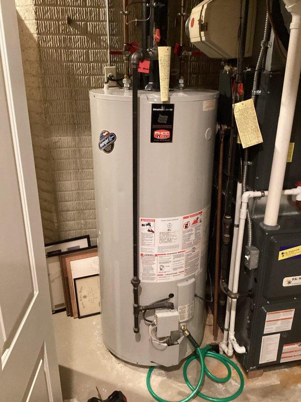 Performed routine maintenance on tanked water heater system located in utility room. Inspected all connections, valves, and components with special attention to the damper assembly and associated copper piping. Visual inspection confirmed proper installation with no signs of leaks or deterioration; system is functioning as intended.