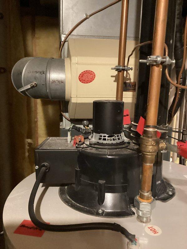 Performed routine maintenance on tanked water heater system located in utility room. Inspected all connections, valves, and components with special attention to the damper assembly and associated copper piping. Visual inspection confirmed proper installation with no signs of leaks or deterioration; system is functioning as intended.