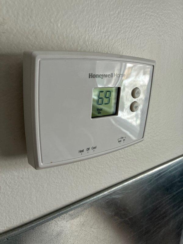 Conducted inspection of damaged AC unit affected by gutter issues. Evaluated HVAC system including ductwork in basement area and verified operation of existing Honeywell thermostat which was reading 69° with heat function operational. Presented replacement options for the damaged air conditioning system.