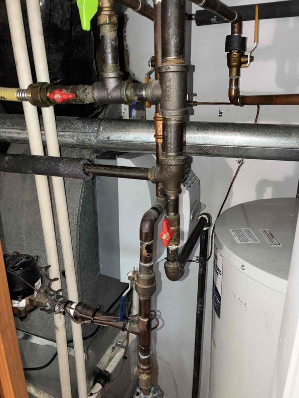Successfully installed an Amana furnace unit with complete ductwork integration, including proper connection of galvanized sheet metal ducts secured with metal clamps. System installation included connection of copper lines and PVC drainage components, with all plumbing infrastructure properly integrated to ensure optimal functionality of the new heating system.