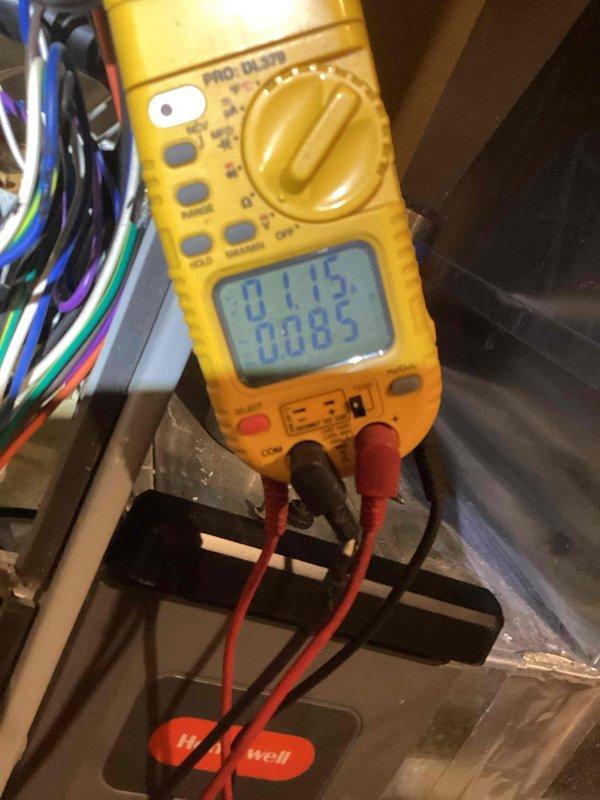 Performed routine heating maintenance service on Honeywell system. Conducted electrical testing with multimeter (PRO DL379) to verify proper voltage readings of 0.115 and 0.085. Observed moisture accumulation near equipment base requiring further monitoring.