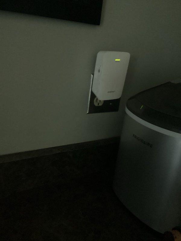 Conducted electrical inspection of premises with focus on GFCI outlet installation and Wi-Fi range extender functionality. Verified proper operation of wall-mounted electronic device showing green indicator light. No electrical hazards identified during inspection; all systems operating within normal parameters.