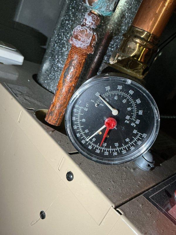 Performed routine maintenance on boiler #8 heating system. Inspected pressure gauge readings and identified significant corrosion and oxidation on copper piping connected to pressure gauge assembly. Documented extensive rust formation and mineral buildup on valve connections requiring future attention.
