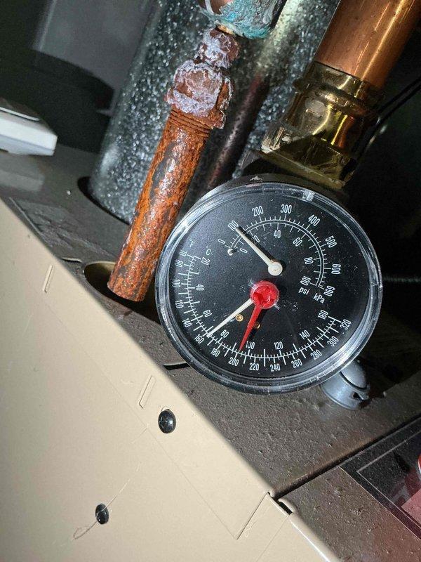 Performed routine maintenance on boiler #8 heating system. Inspected pressure gauge readings and identified significant corrosion and oxidation on copper piping connected to pressure gauge assembly. Documented extensive rust formation and mineral buildup on valve connections requiring future attention.