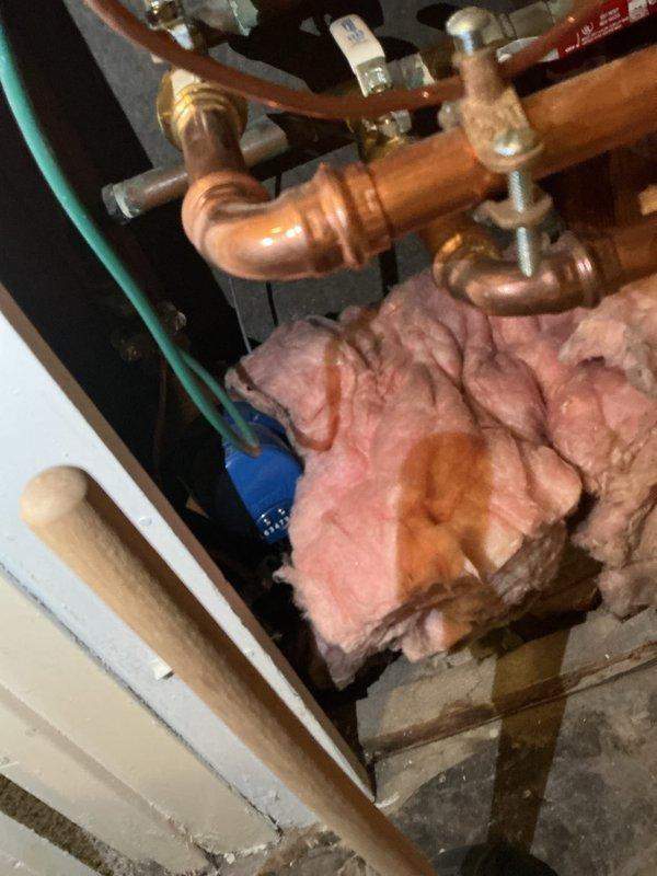 Conducted electrical inspection of residential plumbing system, documenting copper pipe installation with valve assemblies and a digital flow meter. Observed proper installation of shut-off valves and identified potential wall penetration issues requiring attention.