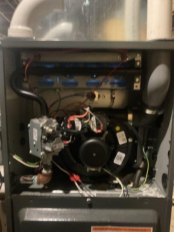 Performed routine heating maintenance on a Goodman furnace system. Inspected all internal components including blower motor, gas valve assembly, heat exchanger, electrical connections, and control board - all found to be in normal working condition with no signs of damage or malfunction. Access was provided via side door as homeowner is currently in assisted living.