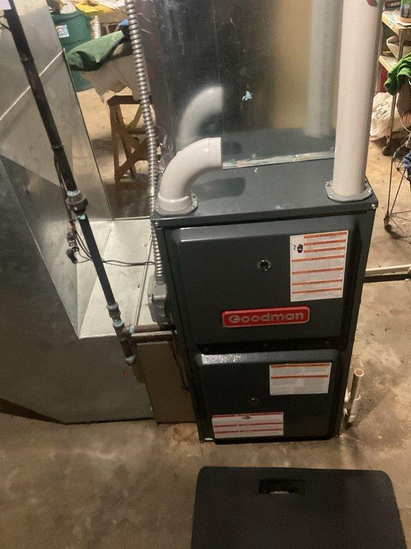 Performed routine heating maintenance on a Goodman furnace system. Inspected all internal components including blower motor, gas valve assembly, heat exchanger, electrical connections, and control board - all found to be in normal working condition with no signs of damage or malfunction. Access was provided via side door as homeowner is currently in assisted living.