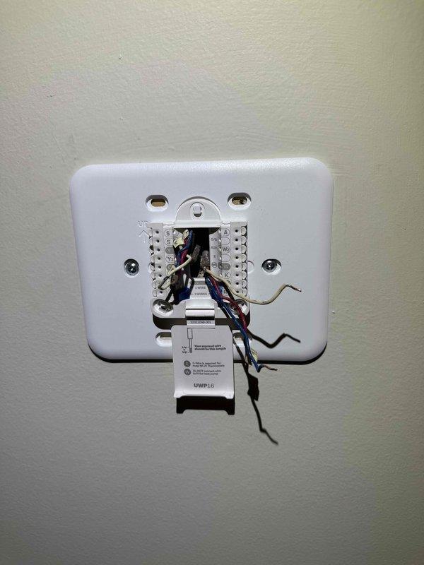 Responded to service call regarding thermostat error message. Removed thermostat wall plate to inspect wiring connections, then reinstalled and tested Honeywell Home ProSeries digital thermostat. Confirmed proper operation with heat set to 79°F and humidity reading at 44%.