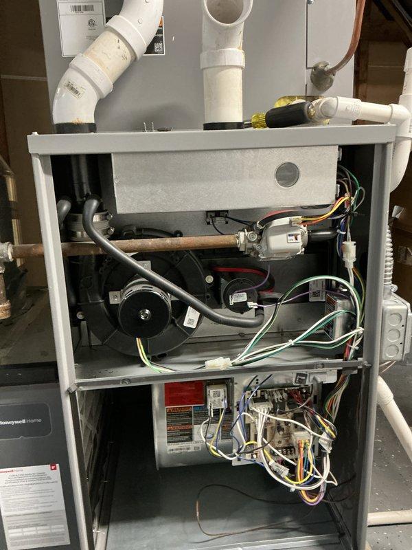 Performed comprehensive heating maintenance on Honeywell furnace system. Inspected internal components including blower motor, control boards, and wiring harnesses; all found to be properly installed and in normal working condition. Checked ventilation system including PVC pipes and connections which were verified secure with no visible damage or abnormal conditions.