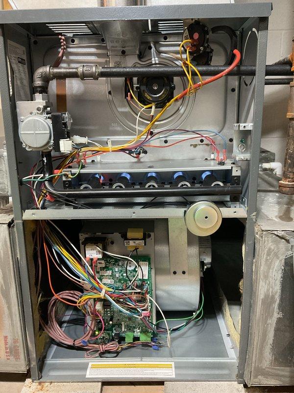 Performed HVAC heating maintenance on two residential furnace systems. Inspected and serviced the first furnace unit with exposed burner assemblies, blower motor, circuit board, and wiring connections to ensure proper functionality. Second unit included maintenance of furnace with attached Aprilaire humidifier, checking ductwork connections, condensate drain system, and verifying all electrical components were operating within specifications.