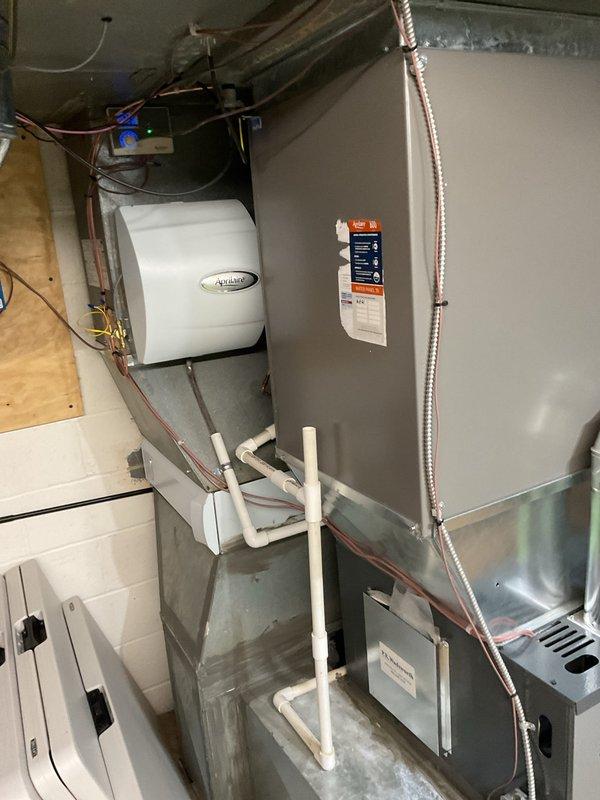 Performed HVAC heating maintenance on two residential furnace systems. Inspected and serviced the first furnace unit with exposed burner assemblies, blower motor, circuit board, and wiring connections to ensure proper functionality. Second unit included maintenance of furnace with attached Aprilaire humidifier, checking ductwork connections, condensate drain system, and verifying all electrical components were operating within specifications.