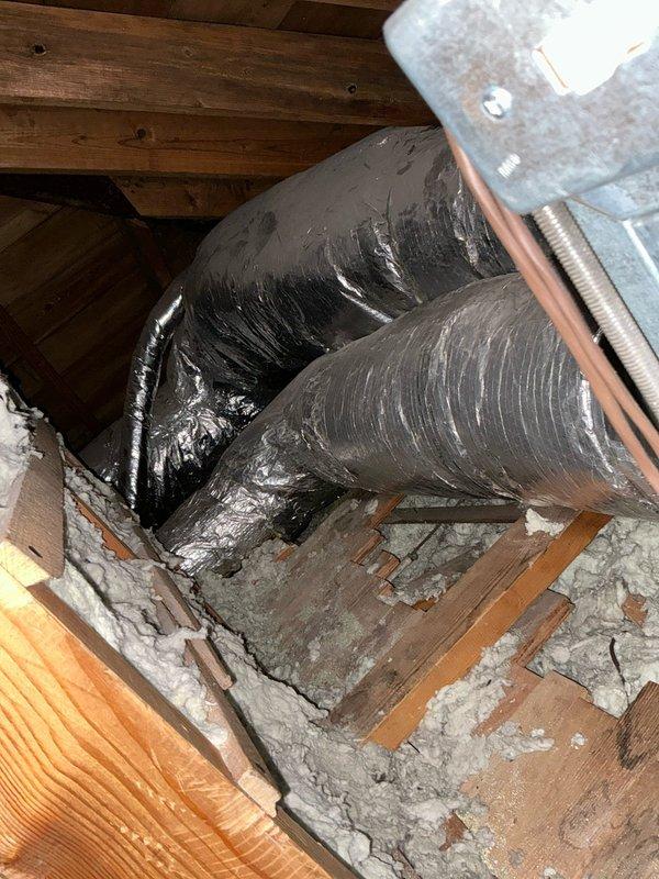 Completed inspection of existing HVAC system in attic space, documenting deteriorated duct insulation and evaluating current installation. Identified aging flexible ducts with compromised insulation and assessed structural conditions affecting system performance. Presented replacement options for both HVAC system and water heater, with additional option for upgraded larger capacity water heater.