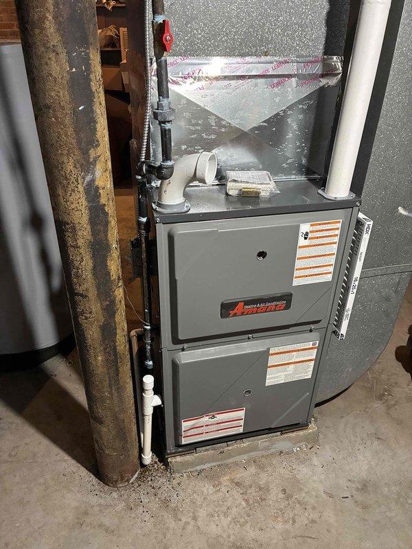 Successfully installed a new Amana high-efficiency 96% AFUE furnace in the basement utility area, including proper connection of PVC venting, condensate drain line, and integration with existing ductwork. All connections were sealed with metal tape and the system was tested for proper operation before completing the job.