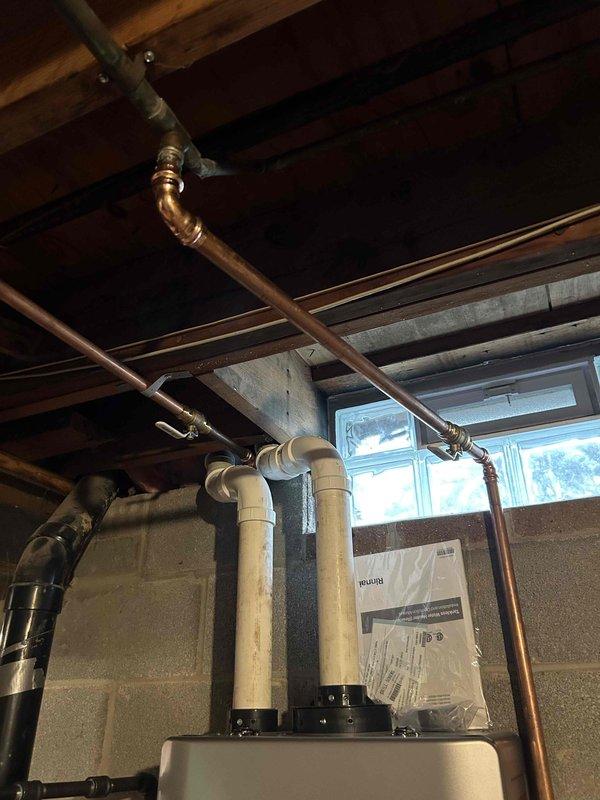Successfully installed a complete 96% efficiency furnace system with AC, humidifier, and tankless water heater. The outdoor condenser unit was properly mounted on a concrete pad with all necessary electrical and refrigerant line connections. Interior installation included copper piping configuration with PVC venting for the high-efficiency appliances, with all systems tested and confirmed operational.