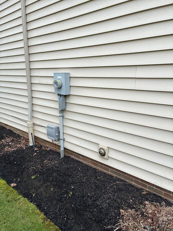 Conducted site assessment for potential furnace replacement, documenting the existing electrical service infrastructure including meter location and available power connections. Photographed exterior electrical setup to evaluate capacity for supporting new HVAC equipment installation requirements.