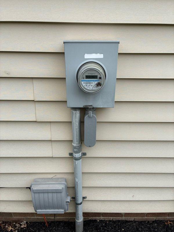 Conducted site assessment for potential furnace replacement, documenting the existing electrical service infrastructure including meter location and available power connections. Photographed exterior electrical setup to evaluate capacity for supporting new HVAC equipment installation requirements.