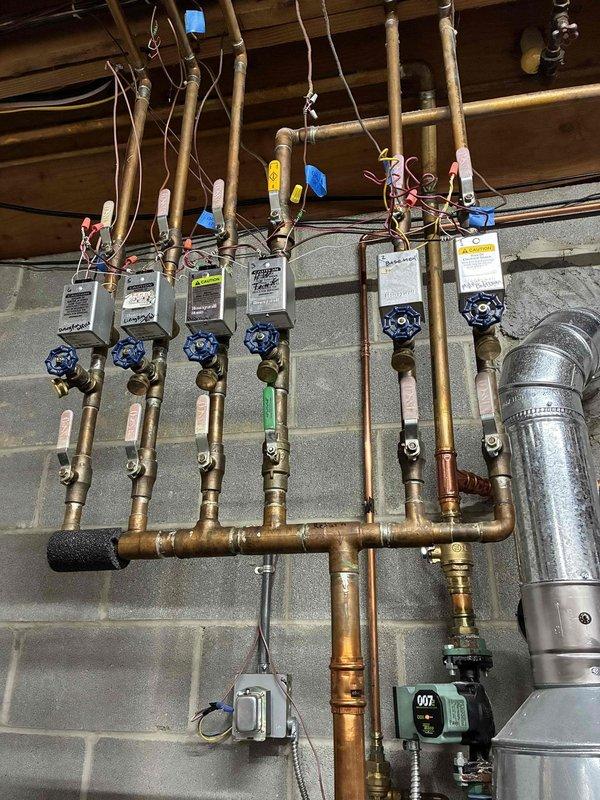 # HVAC Heating Boiler Maintenance Summary

Completed scheduled preventive maintenance service on a multi-zone water boiler heating system. Performed comprehensive inspection of dual boiler units, including examination of heat exchangers, burner assemblies, and associated mechanical components. Verified proper operation of zone valves, circulator pumps, and manifold distribution system serving multiple heating circuits. Inspected copper piping infrastructure, flow meters, and isolation valves for all zones. Confirmed system controls, safety devices, and operational parameters are functioning within manufacturer specifications. All equipment found to be in satisfactory working condition with no immediate repairs required. System operational and ready for continued service.