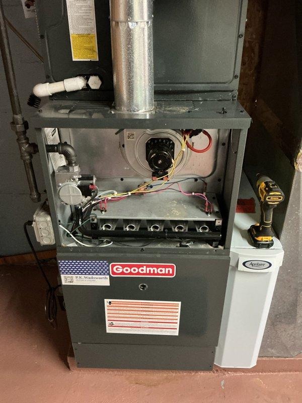 # HVAC Maintenance - Heating System Service Report

Completed comprehensive heating maintenance service on a Goodman brand gas furnace system. Performed full inspection with front access panel removed to evaluate internal components including blower motor assembly, gas burner array, electrical connections, and control systems. Verified proper operation of all burners, checked wire connections (power and control wiring), and inspected heat exchanger for signs of wear or damage. Examined PVC condensate drainage lines for proper installation and functionality. Assessed auxiliary equipment including humidifier unit mounted to furnace cabinet. Confirmed proper ventilation and ductwork connections. All components found to be in satisfactory operating condition with no immediate repairs required. System returned to normal operation following standard maintenance protocol.