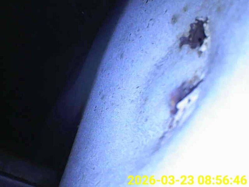 # HVAC Maintenance - Heating System 10+ Years Old

Completed scheduled heating maintenance on aging HVAC system. Upon arrival, coordinated site access per customer requirements and proceeded with comprehensive inspection. Performed thorough examination of evaporator coil assembly, noting accumulated dust and debris between fins typical of systems over 10 years old. Documented curved heat exchanger configuration and verified structural integrity of parallel fin arrangement and cylindrical drum assembly. 

Inspected ductwork and identified areas of concern including visible deterioration with breach in pipe material and surface damage requiring monitoring. Captured photographic documentation of coil condition and duct damage for service records. System components showed signs of age-appropriate wear but remained operational. Completed maintenance protocol and provided visual documentation of current system condition for future reference.