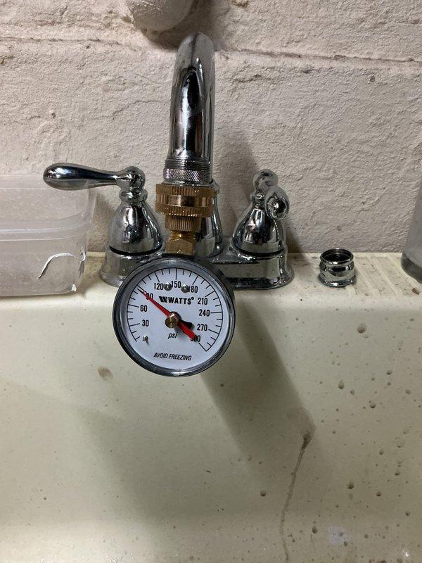 # Plumbing Inspection Service Report

Completed comprehensive plumbing inspection of bathroom faucet installation, utilizing pressure gauge to test water pressure at fixture, which measured within normal operating parameters. Inspected two-handle chrome faucet assembly mounted on bathroom sink, verified proper installation of all components including spout, handles, and drain assembly, and confirmed all fixtures were functioning correctly with no visible leaks or defects.