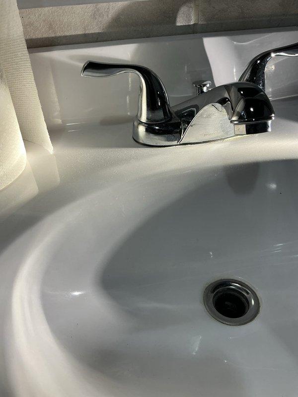 # Plumbing Inspection Service Report

Completed comprehensive plumbing inspection of bathroom faucet installation, utilizing pressure gauge to test water pressure at fixture, which measured within normal operating parameters. Inspected two-handle chrome faucet assembly mounted on bathroom sink, verified proper installation of all components including spout, handles, and drain assembly, and confirmed all fixtures were functioning correctly with no visible leaks or defects.