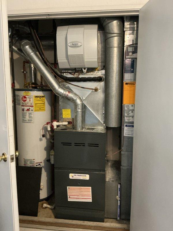 # HVAC Maintenance - Heating System Service Report

Completed comprehensive heating maintenance on residential forced-air furnace system. Performed diagnostic testing of control board and safety circuits using digital multimeter, verifying proper voltage readings and component functionality. Inspected internal electrical connections, control board terminals, and wiring harnesses for signs of wear or deterioration. All connections found secure with no evidence of overheating or corrosion.

Evaluated integrated humidification system, confirming proper installation and operational status of wall-mounted Aprilaire humidifier unit connected to main ductwork. Examined ductwork connections and joints throughout the system for air leakage or separation. Inspected water heater installation in utility closet, noting proximity to HVAC equipment and verifying adequate clearances for safe operation and maintenance access.

Conducted visual inspection of furnace cabinet, heat exchanger accessibility