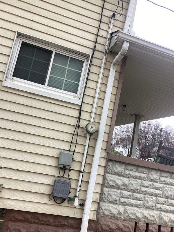 # Electrical Inspection Service Report

Completed comprehensive electrical inspection of residential service equipment and exterior installations. Documented exterior meter base, service entrance conductors, and associated conduit routing along vinyl siding, verifying proper mounting and weather protection. Inspected interior electrical panel, photographing breaker configuration, bus bar connections, neutral bar terminations, and service entrance cable routing. All components were visually assessed for code compliance, proper installation methods, and operational condition. Documentation includes detailed imagery of both exterior service equipment and interior panel wiring for record purposes.