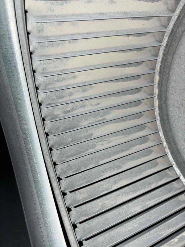 # HVAC Heating Maintenance Service Report

Completed scheduled preventive maintenance service on residential furnace system as part of ongoing heating maintenance program. Upon inspection, discovered significant frost and ice crystal accumulation on evaporator coil assembly and horizontal louvers, indicating potential airflow restriction or refrigerant issue affecting system performance. Removed and documented a small U-shaped metal wire component that was found loose within the system, which could have posed risk of obstruction or damage to moving parts if left unaddressed. Thoroughly inspected air return vent assembly and surrounding HVAC components for additional debris or mechanical concerns. System evaluated for proper operation following maintenance procedures, with photographic documentation captured for service records.
