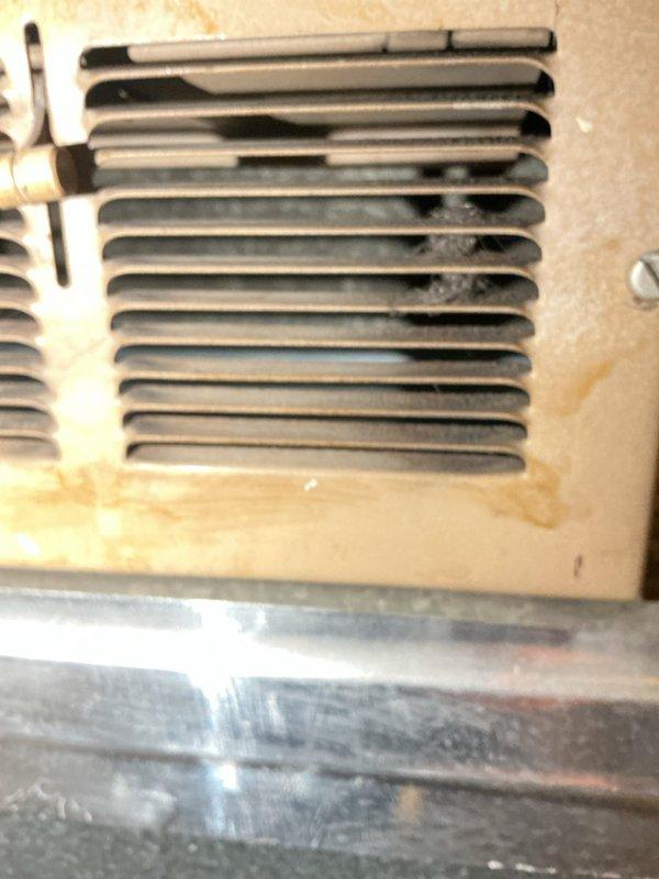 # Service Report

Responded to no-heat callback for unit serviced five days prior. Upon arrival, conducted thorough system inspection and photographed equipment condition. Examined furnace cabinet, air filter installation, and heat exchanger assembly. Documented visible dust and debris accumulation on coil fins and heat exchanger surfaces. Inspected copper refrigerant lines and internal components for proper operation. Filter showed signs of restricted airflow. Assessed overall system cleanliness and identified maintenance concerns that may impact heating performance. Verified equipment installation and component accessibility in basement utility area.