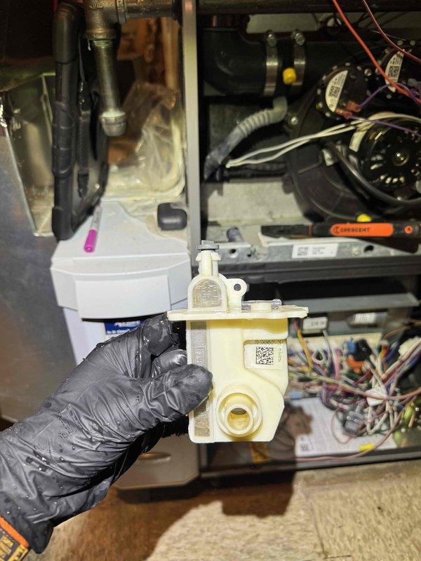 # HVAC Heating System Maintenance

Completed comprehensive heating maintenance service on residential HVAC system. Performed detailed inspection of furnace components, including removal and examination of condensate pump assembly with integrated valve mechanism. Inspected blower motor assembly, electrical connections, and wiring harness for proper operation and secure connections. Verified condensate drain pan condition and drainage system functionality.

Conducted maintenance check on Navien tankless water heater unit. Confirmed operational status with digital display reading 64.7°C. Inspected control panel functionality, plumbing connections including PVC piping, brass fittings, and inlet/outlet valves. Verified Energy Star certified unit operating within normal parameters. All heating system components found in good working order with no immediate service needs identified.