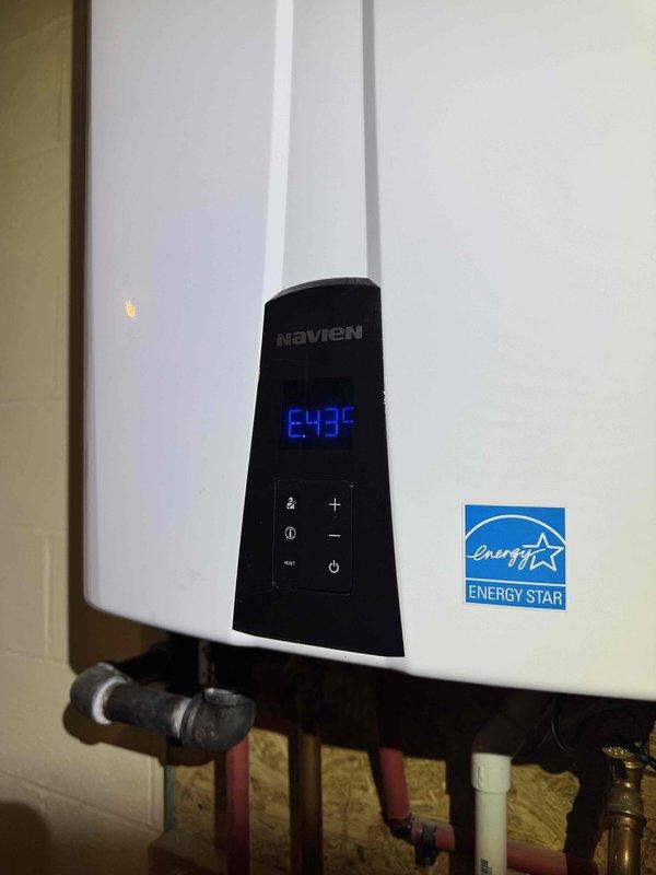 # HVAC Heating System Maintenance

Completed comprehensive heating maintenance service on residential HVAC system. Performed detailed inspection of furnace components, including removal and examination of condensate pump assembly with integrated valve mechanism. Inspected blower motor assembly, electrical connections, and wiring harness for proper operation and secure connections. Verified condensate drain pan condition and drainage system functionality.

Conducted maintenance check on Navien tankless water heater unit. Confirmed operational status with digital display reading 64.7°C. Inspected control panel functionality, plumbing connections including PVC piping, brass fittings, and inlet/outlet valves. Verified Energy Star certified unit operating within normal parameters. All heating system components found in good working order with no immediate service needs identified.