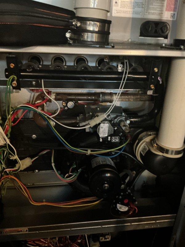 Completed scheduled preventive maintenance on residential gas furnace heating system. Performed comprehensive inspection of all major components including heat exchanger, burner assembly, blower motors, electrical controls, and safety systems. Verified proper operation of circuit board, relays, contactors, and all electrical connections throughout the control panel and air handler unit. Inspected gas line connections, ductwork attachments, and PVC venting for secure installation and proper sealing. Confirmed both blower motors functioning correctly with appropriate wiring connections. All safety devices tested and operating within manufacturer specifications. System running efficiently with no deficiencies noted at time of service.