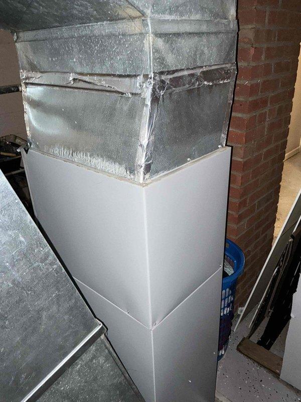 Responded to no heat call on forced air system. Evaluated existing furnace and determined unit required replacement. Provided customer with three gas furnace replacement options ranging from 80% to 96% nominal AFUE efficiency ratings. Documented existing ductwork configuration in basement utility area, including metal supply ductwork with white painted lower enclosure and flexible connector components. Photographed installation area showing exposed brick walls, concrete flooring, and current HVAC infrastructure to support replacement estimate and planning.