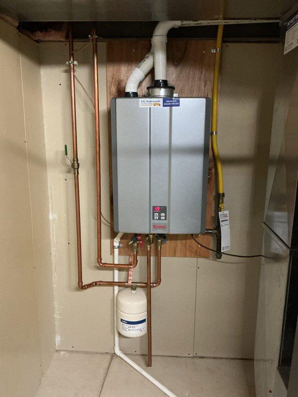 Completed plumbing inspection addressing slow faucet leak in upstairs bathroom and evaluated shower access panel plumbing configuration. Assessed current system requiring full home water shutdown for shower service and provided recommendations for installing isolation valves to allow localized shutoff capability. Documented existing plumbing infrastructure including tankless water heater installation, main water meter assembly with shutoff valves, and copper supply line routing for quote preparation.