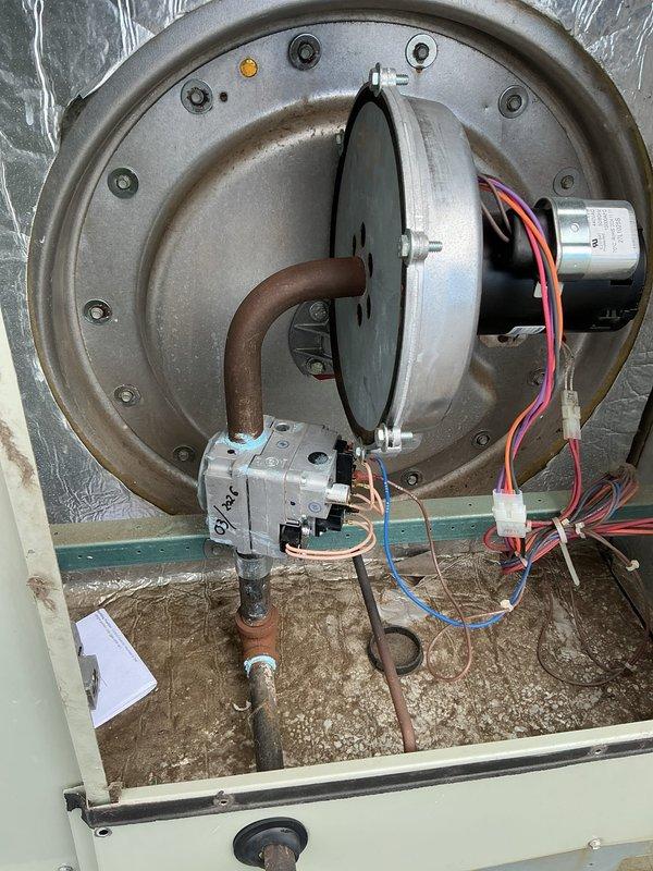 Responded to return service call for persistent no heat condition on 6-9 year old furnace system. Upon inspection, found blower assembly with dual motors showing signs of electrical connection issues and accumulated debris in drain pan affecting system operation. Identified dirty air filter restricting airflow, which was contributing to system malfunction. Cleaned blower compartment, verified motor wiring connections, replaced air filter, and tested system operation to restore proper heating function.