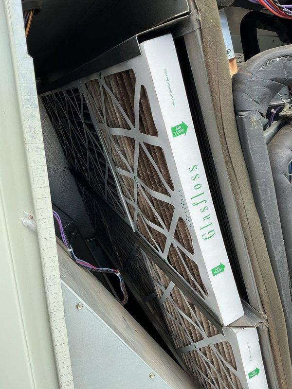 Responded to return service call for persistent no heat condition on 6-9 year old furnace system. Upon inspection, found blower assembly with dual motors showing signs of electrical connection issues and accumulated debris in drain pan affecting system operation. Identified dirty air filter restricting airflow, which was contributing to system malfunction. Cleaned blower compartment, verified motor wiring connections, replaced air filter, and tested system operation to restore proper heating function.